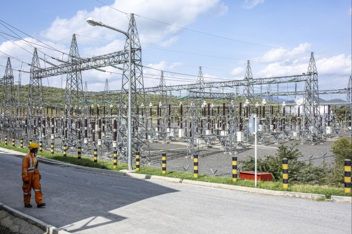 A worker passes an electricity substation at the Olkaria Geothermal Complex